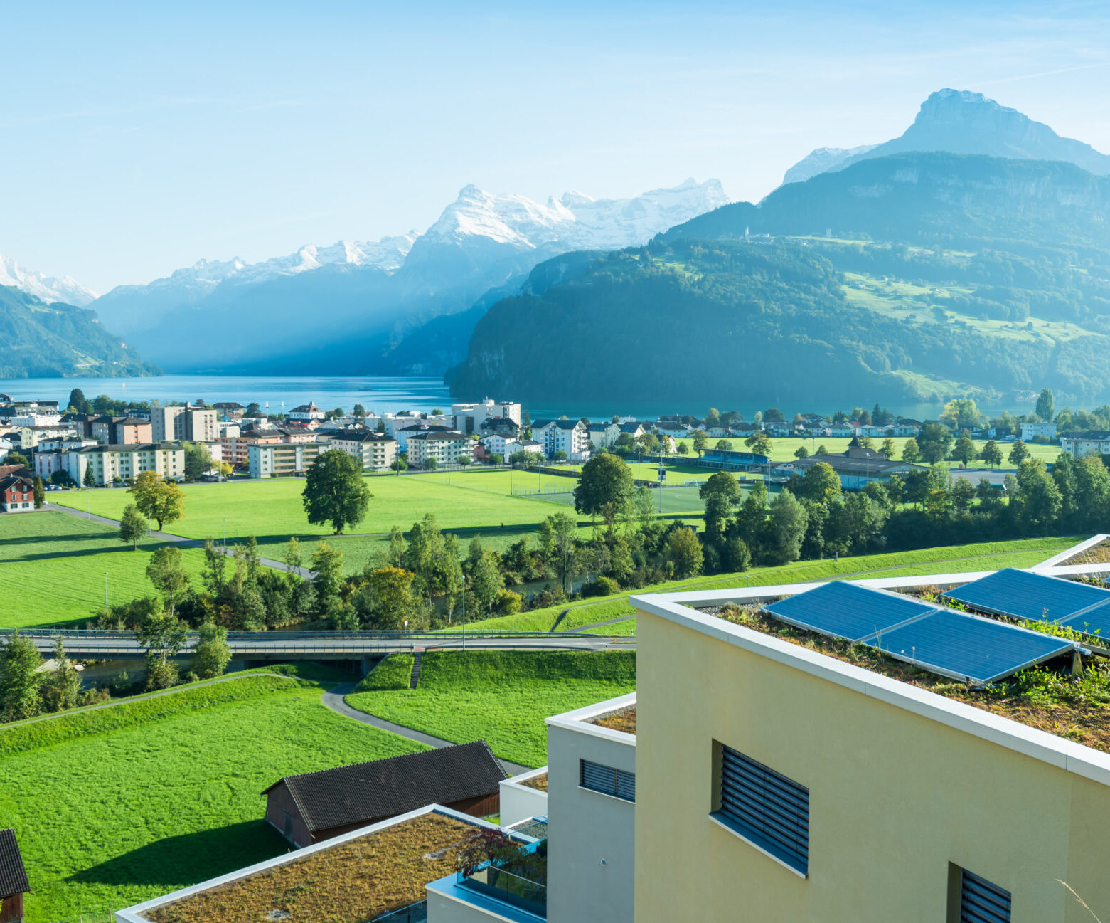 Panorama of the canton Schwyz. Residential houses, architecture. In the foreground a roof with solar panels. Small towns of Europe. Switzerland. Lake Lucerne.